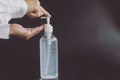 Hand useing alcohol cleaning gel bottle isolate on black background, image for aroma spa and Covid-19 out break concept