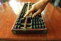 Hand using abacus on wooden table. stock photo Royalty Free Stock Photo