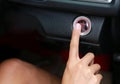 Hand using Car engine start-stop button Royalty Free Stock Photo