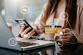 .Close up of Hand using credit card and smartphone, laptop computer on wooden desk with VR icon chart graph diagram