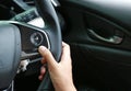 Hand using Cruise control buttons on modern car and speed limitation Royalty Free Stock Photo