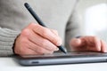 Hand using digital pen on tablet screen. creative work and digital art design interface Royalty Free Stock Photo
