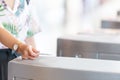 Hand using electronic card key for access to entering the turnstile Royalty Free Stock Photo