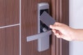 Hand using electronic smart contactless key card for unlock door in hotel or house Royalty Free Stock Photo