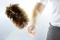 A hand using a feather duster Royalty Free Stock Photo