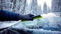 Hand using ice scraper removing frost from car windshield Royalty Free Stock Photo