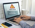 Hand Using Laptop with Warning Screen: New Email Alerts, Hacked Password & Personal Data Theft