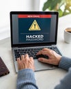 Hand Using Laptop with Warning Screen: New Email Alerts, Hacked Password & Personal Data Theft