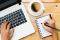 Hand using laptop and write note inspire idea on wood Royalty Free Stock Photo