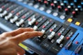 Hand using mixing console,Sound recording studio mixing desk wit