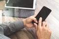 Hand using mobile payments online shopping,omni channel,icon customer network,in modern office wooden desk, blank interface scree Royalty Free Stock Photo