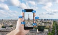 Hand using mobile smart phone taking photo of Eiffel tower in Paris, France with social media and social network notification icon Royalty Free Stock Photo
