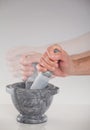 A hand using a mortar and pestle Royalty Free Stock Photo