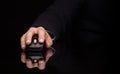 Hand using mouse on dark background Royalty Free Stock Photo