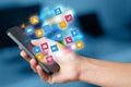 Hand using phone with colorful application icons and symbols concept Royalty Free Stock Photo