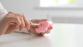 Hand using pink pencil sharpener at desk Royalty Free Stock Photo