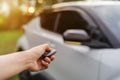 Hand using remote key to unlocked car Royalty Free Stock Photo