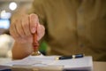 Hand using a rubber stamp on official papers, representing approval process, legal documentation, and certified paperwork. Royalty Free Stock Photo