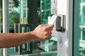 Hand using security key card scanning to open the door to entering private building. Home and building security system