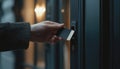 Hand Using Security Key Card To Scan And Access Private Building With Advanced Lock Technology For