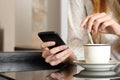 Hand using a smart phone during breakfast at home Royalty Free Stock Photo