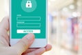 Hand using smart phone with password login on screen over blur b Royalty Free Stock Photo