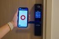 Hand using smartphone for close digital door lock at home or apartment. NFC Technology, Fingerprint scan, keycard, PIN number,