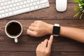 Hand using smartwatch on desk top view Royalty Free Stock Photo