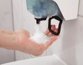 Hand using soap dispenser Royalty Free Stock Photo