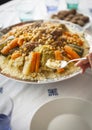 Couscous traditional moroccan with hand and spoon