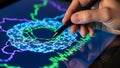 Hand using stylus on digital tablet displaying data visualization and network analysis Royalty Free Stock Photo