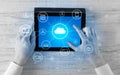 Hand using tablet with centralized cloud computing system concept