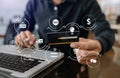 .Close up of Hand using credit card and smartphone, laptop computer on wooden desk with VR icon chart graph diagram