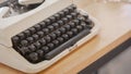 Hand is using Vintage typewriters on wooden table