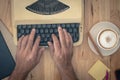 Hand is using Vintage typewriters on wooden table