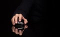 Hand using mouse on dark background Royalty Free Stock Photo