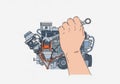 A hand is using a wrench to work on a detailed illustration of an internal combustion engine. The Royalty Free Stock Photo