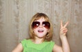 Hand victory gesture little girl funny sunglasses