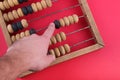 Hand on vintage wooden abacus Royalty Free Stock Photo