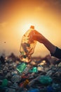 Hand of volunteers putting garbage on the beach