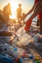 Hand of volunteers putting garbage on the beach