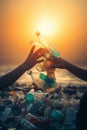 Hand of volunteers putting garbage on the beach