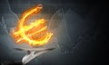 Hand of waitress presenting flaming euro sign. Royalty Free Stock Photo