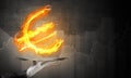 Hand of waitress presenting flaming euro sign. Royalty Free Stock Photo