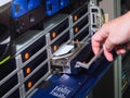 The hand was pulling a harddisk out of rack mount server Royalty Free Stock Photo