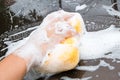 Hand washing Brown Car with yellow sponge and bubbles Foam