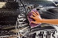 Hand washing a car with a microfiber cloth