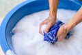 Hand washing clothes in Blue basin Royalty Free Stock Photo