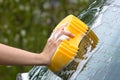 Hand washing the rear screen of a car