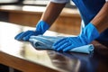 Hand with washing sponge cleaning surface of kitchen tabletop